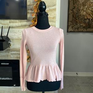 Divided pink long sleeve shimmery peplum top.